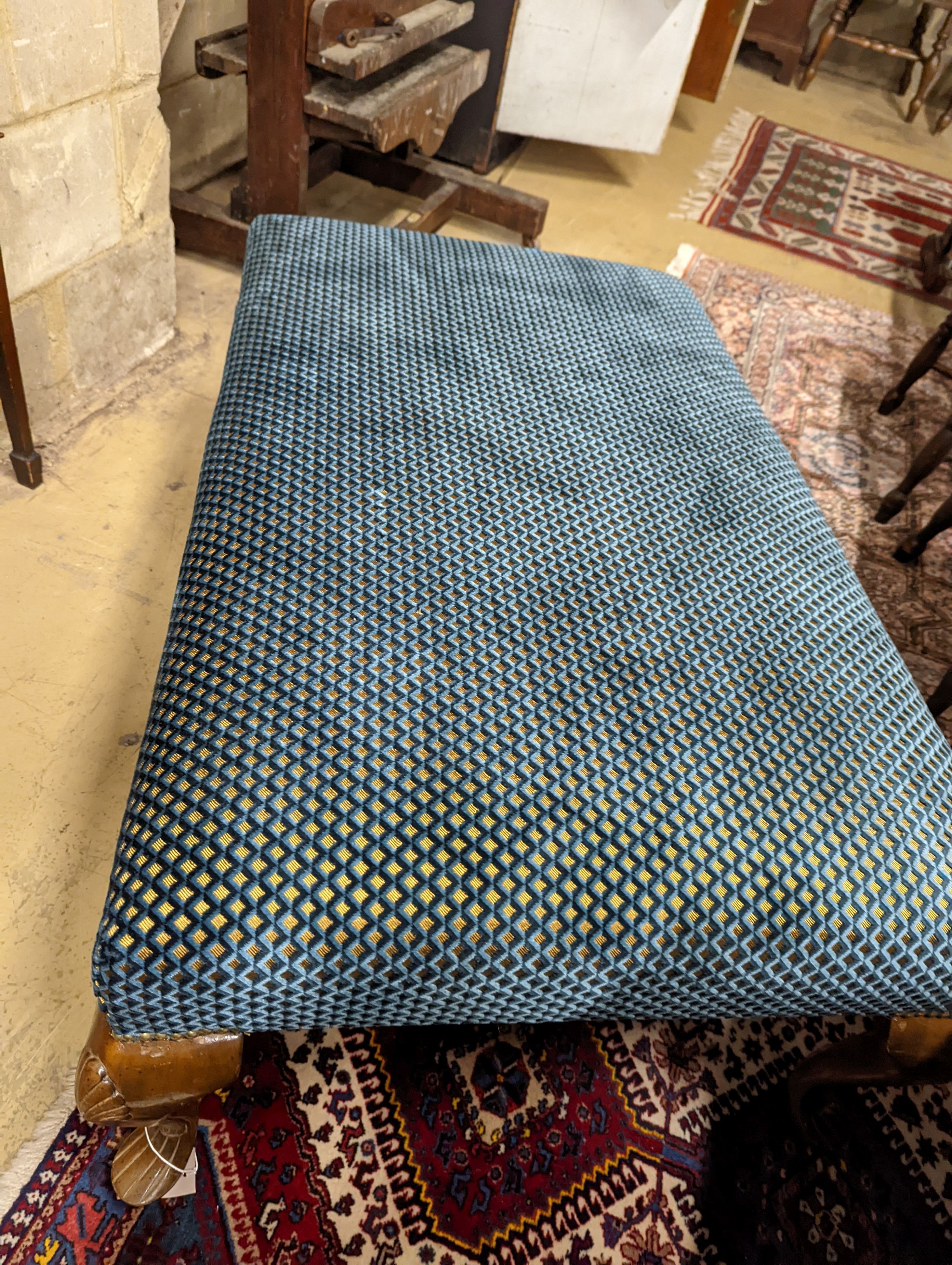 An upholstered footstool. W-117cm, D-73cm, H-44cm.